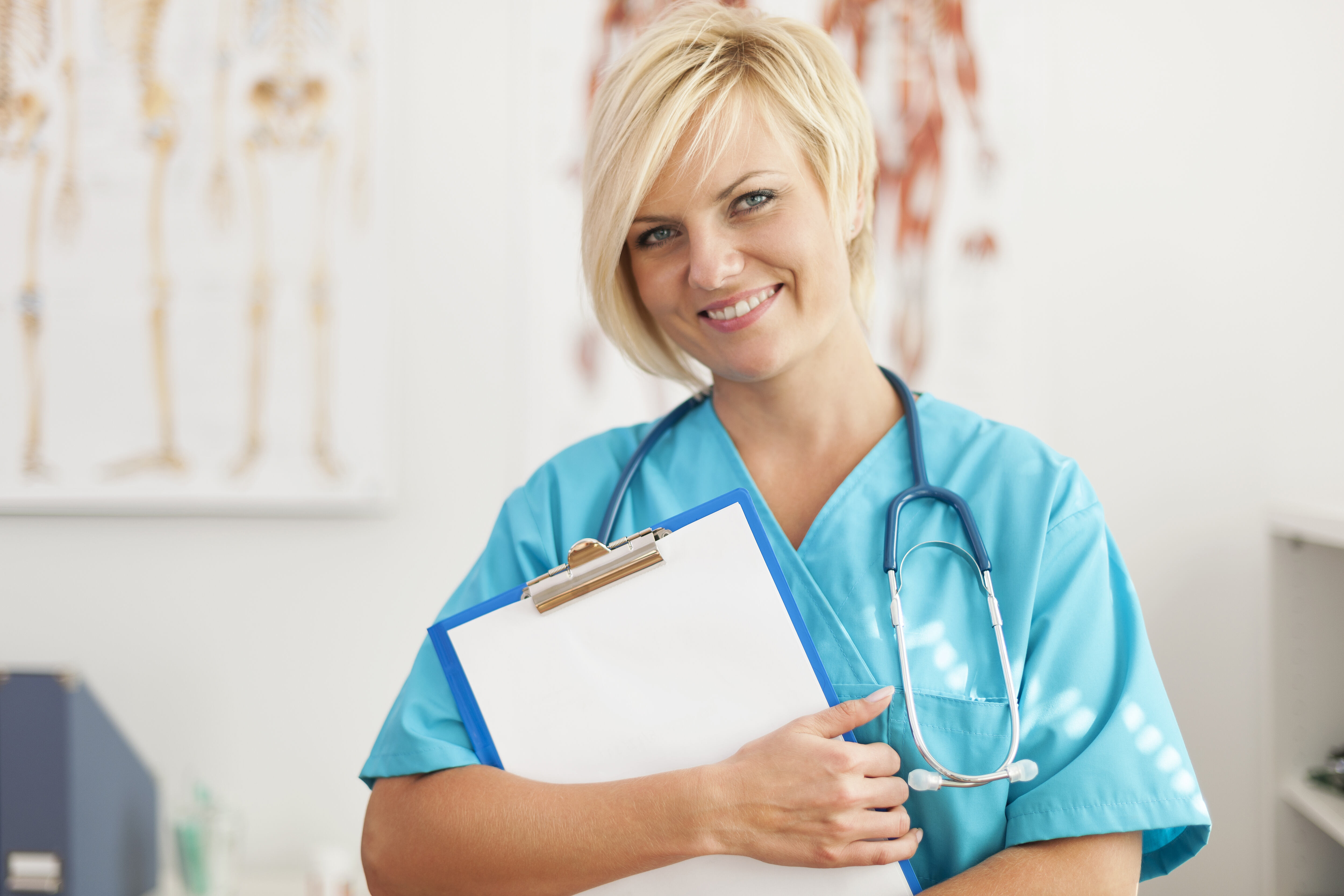 Portrait of smiling blonde female surgeon