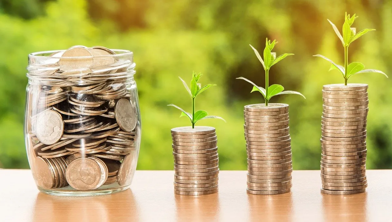 money in a jar and in piles